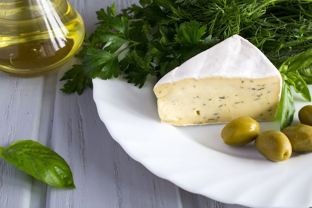 Cheese with herbs on the white plate