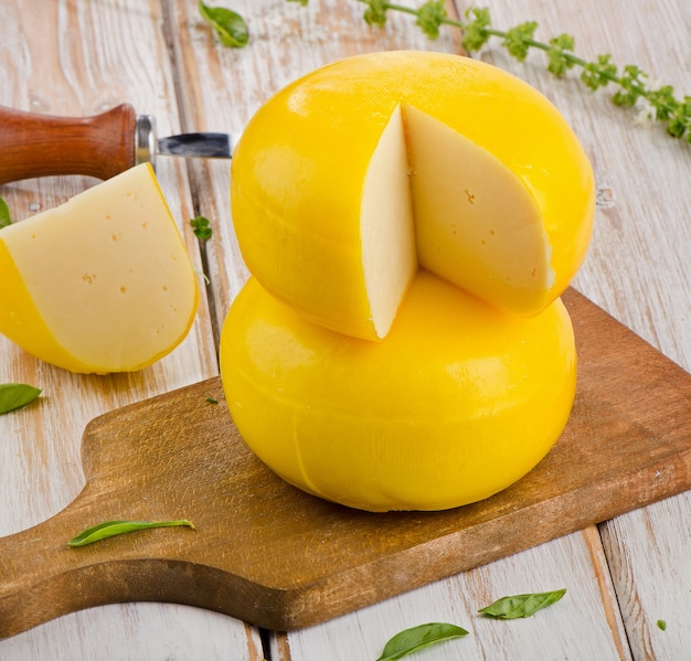 Cheese with herbs on wooden table