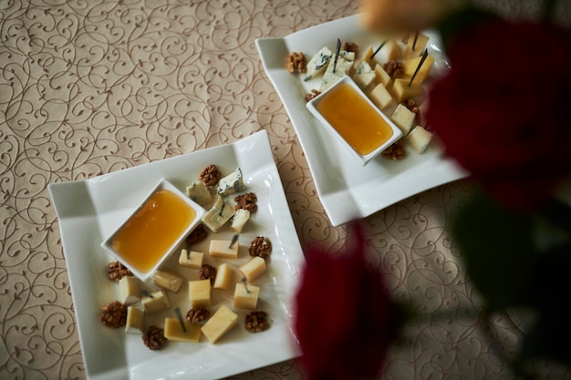 Cheese with honey on a white plate Snacks