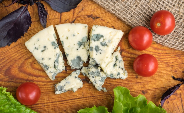 Photo cheese with mold on rustic background