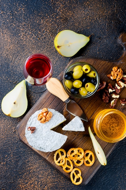 Cheese with mold with berries, snacks and wine