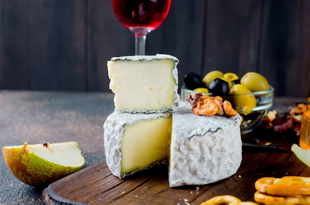 Cheese with mold with berries, snacks and wine