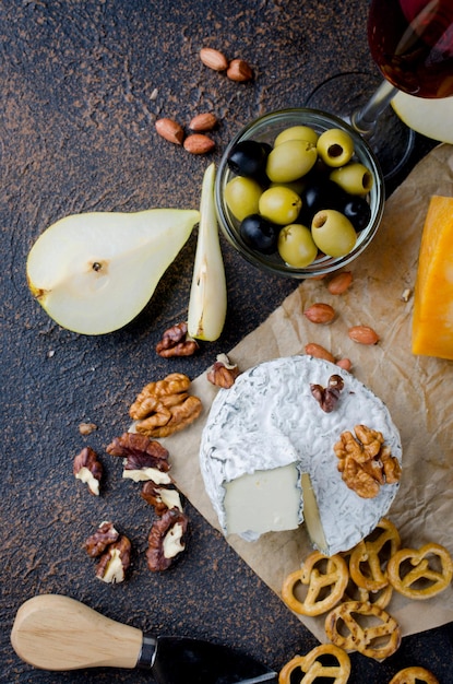 Cheese with white mold berryes nuts and crackers