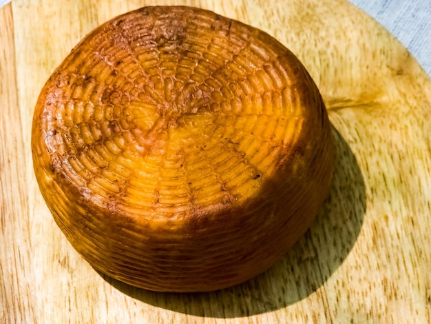 Cheese on a wooden board Background Georgian cheese suluguni