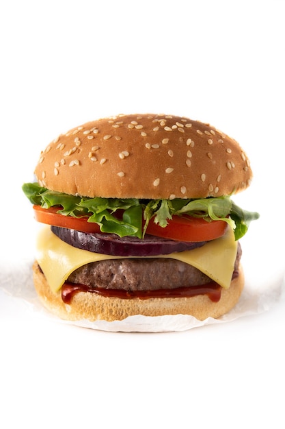 Cheeseburger with beef,tomato, lettuce and onion on wooden table