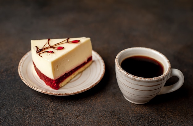 Cheesecake - cake on a white plate and  coffee on stone background with copy space for your text