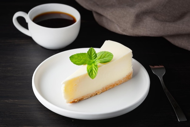 Cheesecake en kopje zwarte koffie op een houten tafel