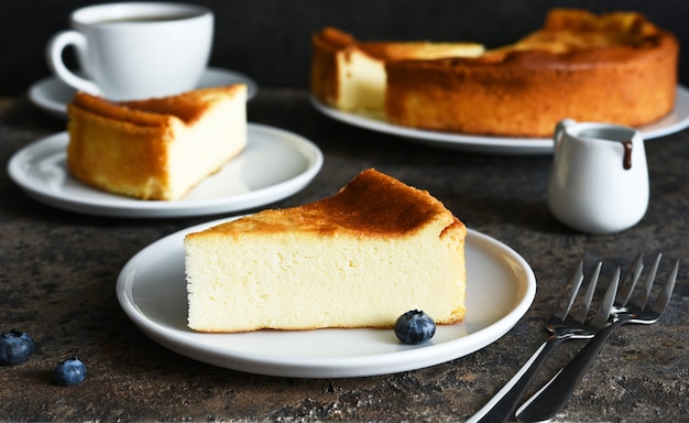 Cheesecake new york. Slice cheesecake and a cup of coffee on the kitchen table.