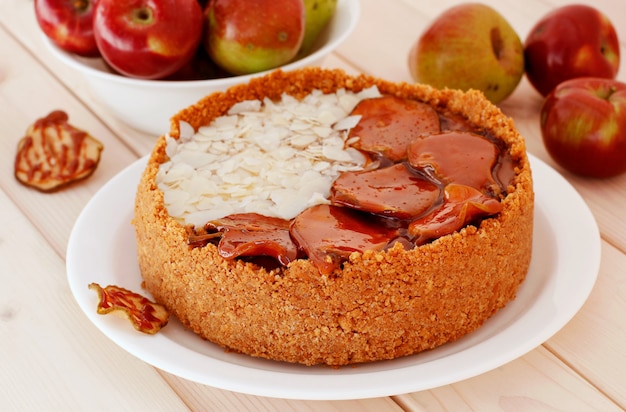 Cheesecake on a plate on wooden table.