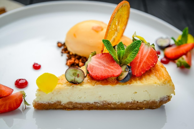 Cheesecake with berries and sorbet on plates