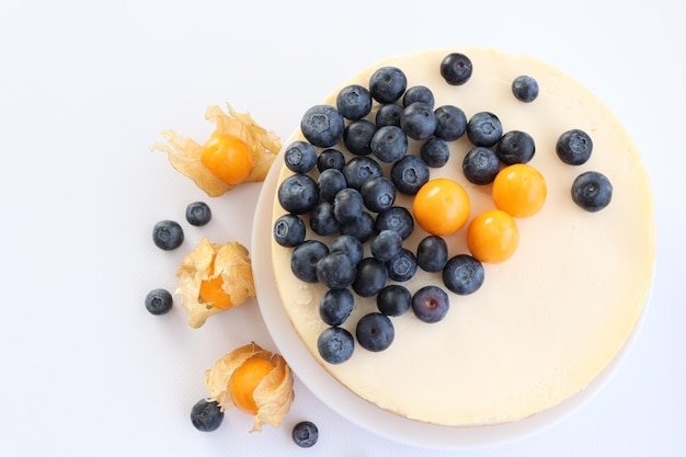 Cheesecake with berries on a white background