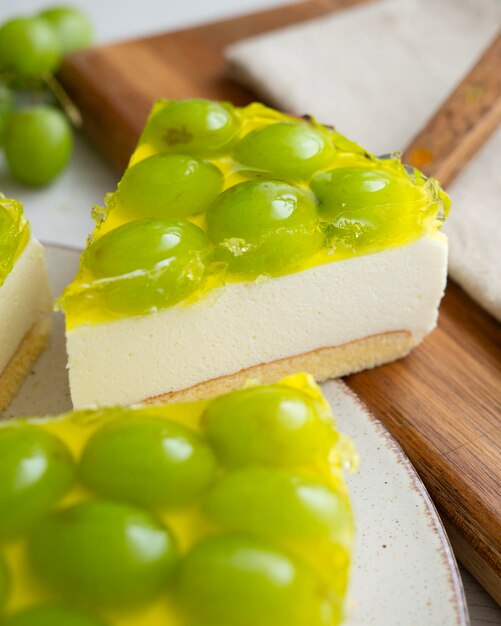 Cheesecake with grapes on a sponge cake base