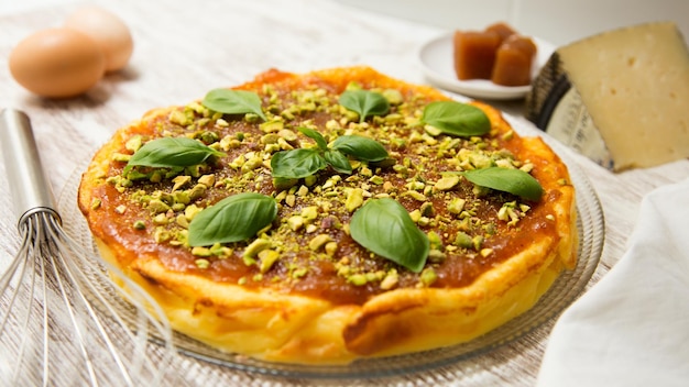 Cheesecake with quince and pistachio topping.