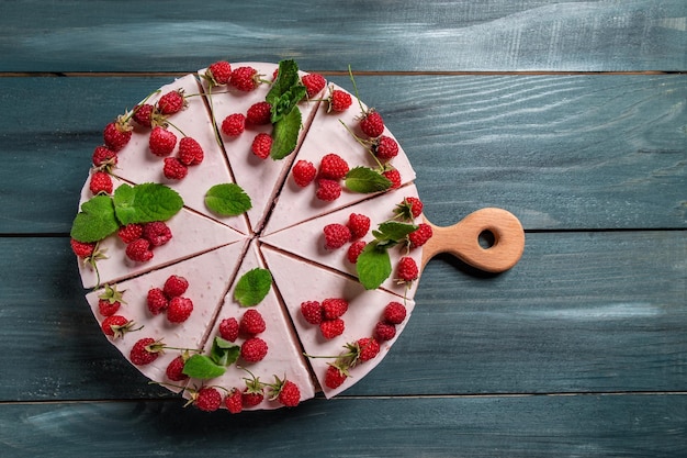 Cheesecake with raspberries and mint no baked cheesecake\
raspberry berries cake banner menu recipe place for text top\
view