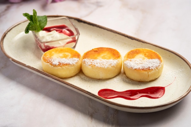 cheesecakes with sour cream and jam for breakfast photo for a restaurant photo for a menu