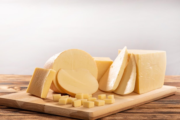 cheeses beautiful pieces of cheese and accessories placed on rustic wood light background selective focus