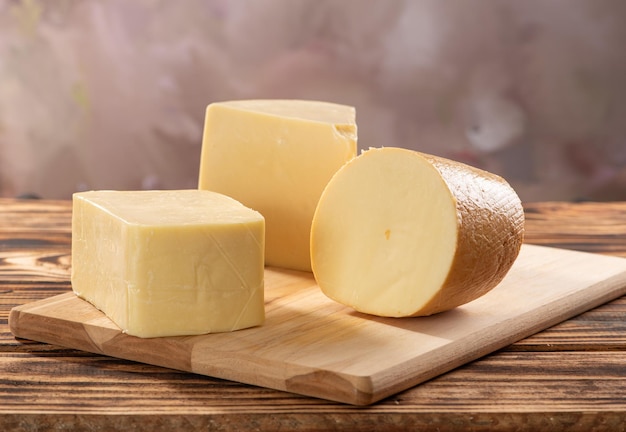Cheeses beautiful pieces of cheese placed on rustic wood selective focus