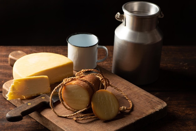 Cheeses scene with different cheeses and accessories over rustic wood selective focus