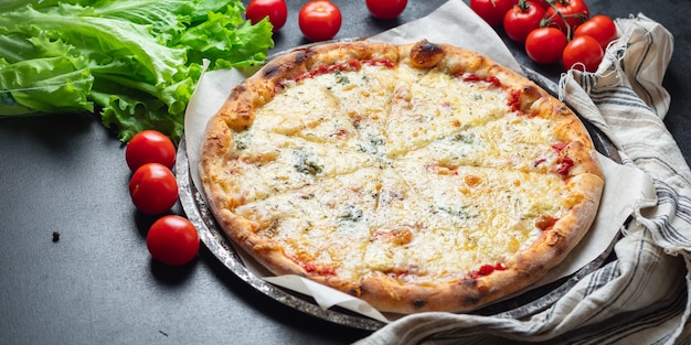 Cheesy pizza fast food 4 cheese assorted types food background