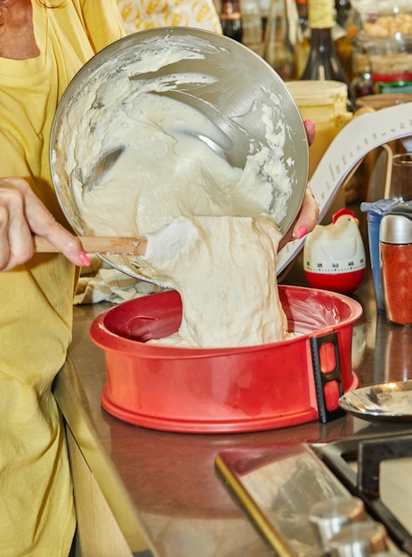 Chef adds the dough to the silicone pie mold