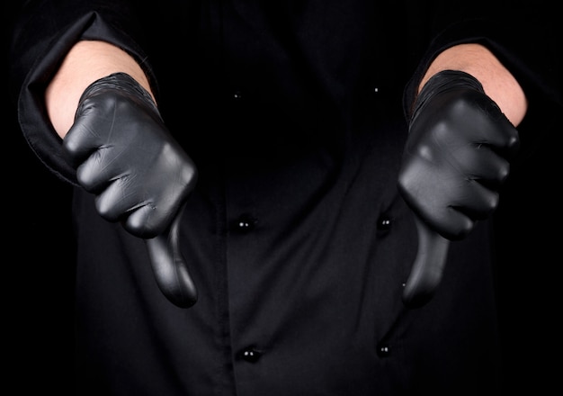 Chef in black latex gloves shows gesture not like