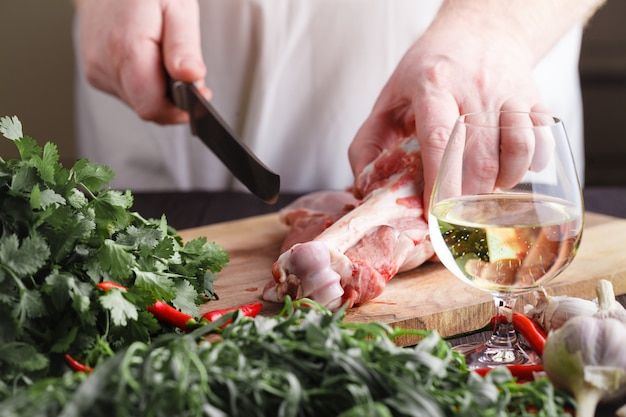 Chef Butcher cutting lamb meat with knife