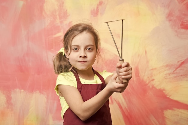 Chef child with masher for potato