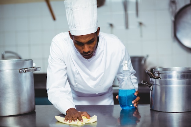 Chef cleaning kitchen counter