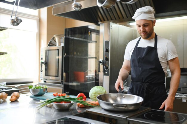 Chef cook preparing vegetables in his kitchen