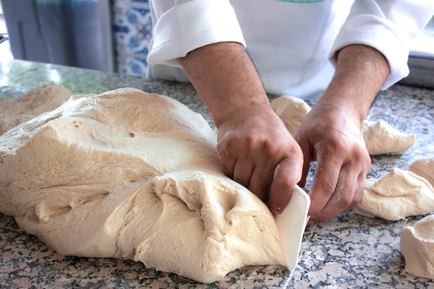 Chef cook works with a yeast dough