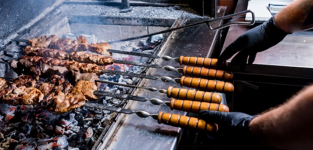 Chef cooking delicious beef and pork barbecue on grill. Georgian restaurant.