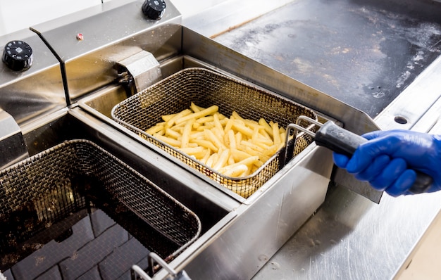 The chef cooking french fries. Restaurant.