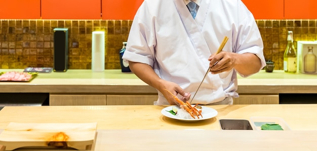 Chef cooking lobster sashimi