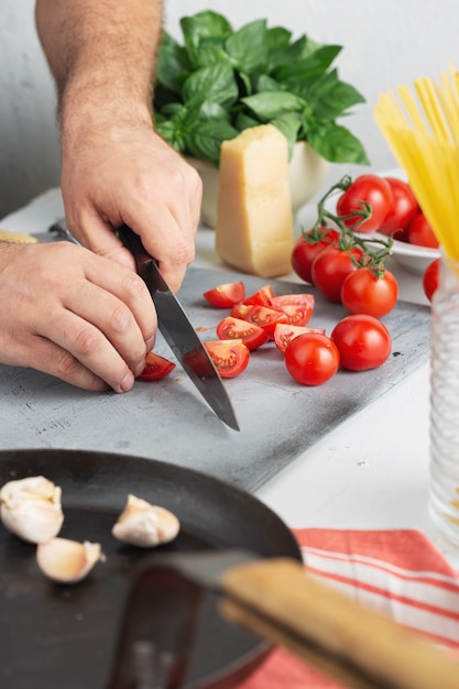 Chef cooking pasta with tomatoes