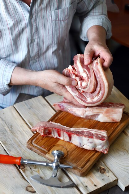 A chef cooking raw pork ribs