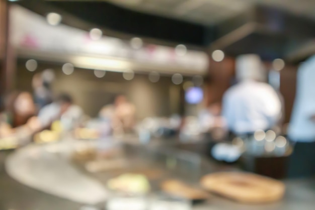 Chef cooking in restaurant kitchen abstract blurred defocused background