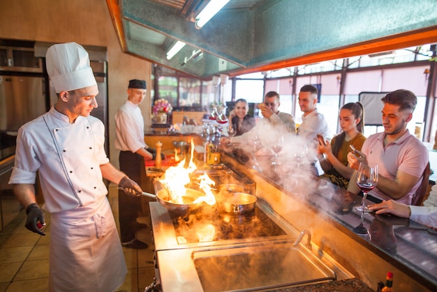 Chef cooking seafood in a restaurant.