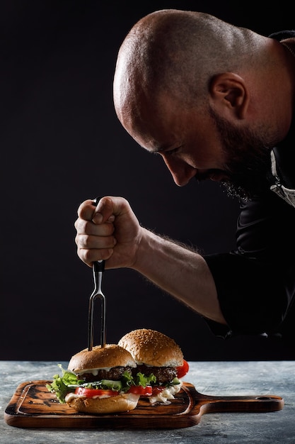 The chef cooks burgers in the restaurant