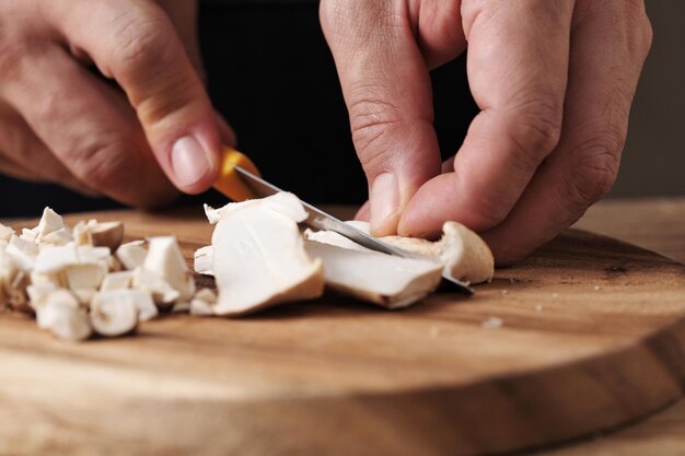 chef cut mushrooms on wooden tray