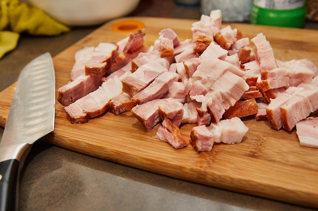 Chef cuts bacon in the kitchen for recipe