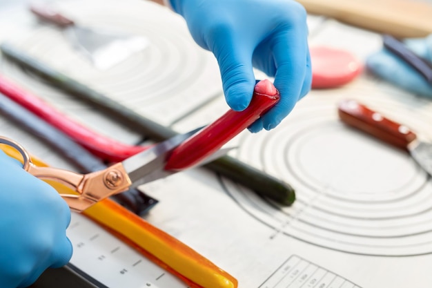 Chef cuts hot caramel and lollipops with scissors Candy Handmade