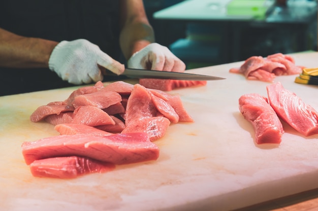 Chef cutting bluefin tuna in kuromon market