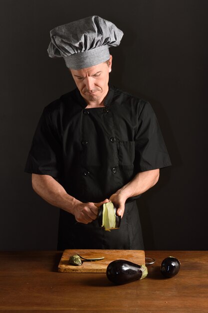 Chef cutting  eggplant,