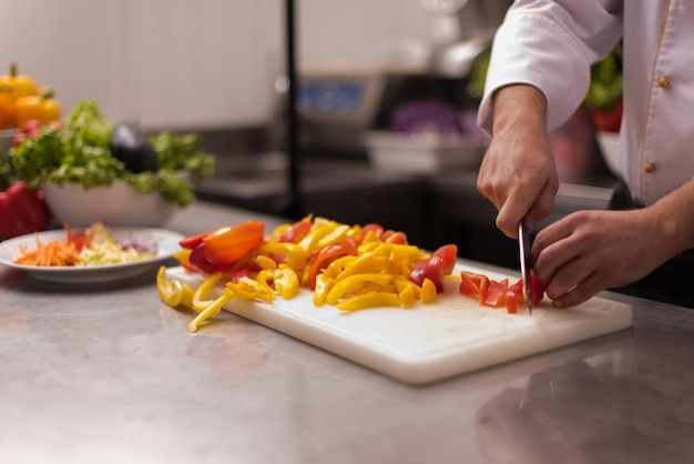 Chef cutting fresh and delicious vegetables for cooking or salad