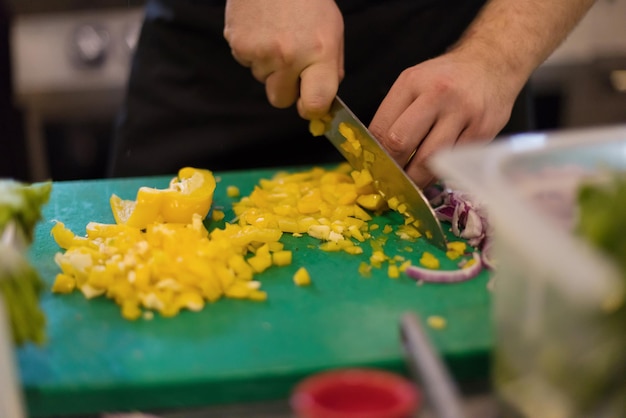 Chef cutting fresh and delicious vegetables for cooking or salad