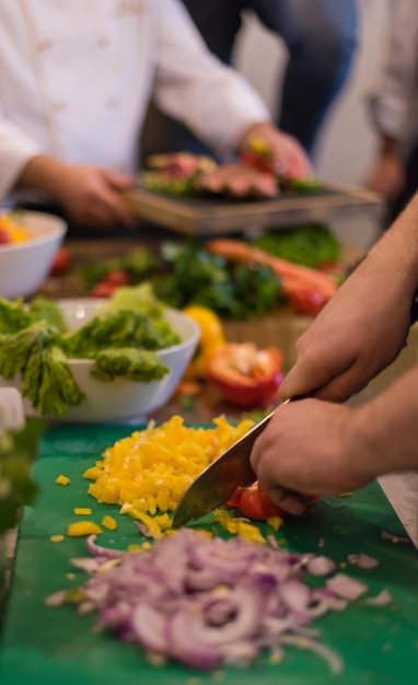 Photo chef cutting fresh and delicious vegetables for cooking or salad