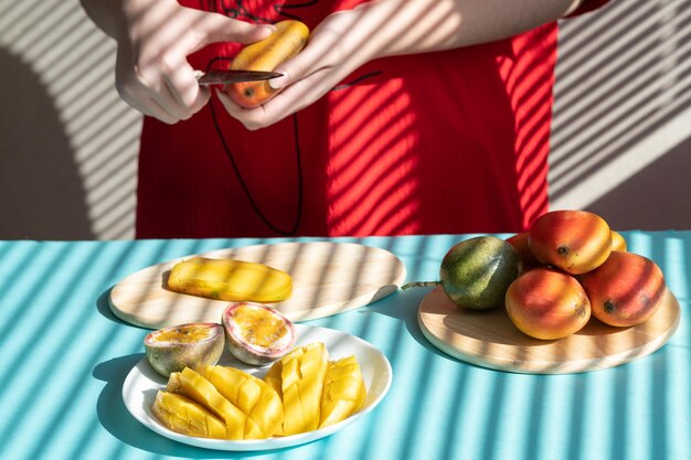 chef cutting fruits Female hands cutting mango and passion fruit fruit breakfast