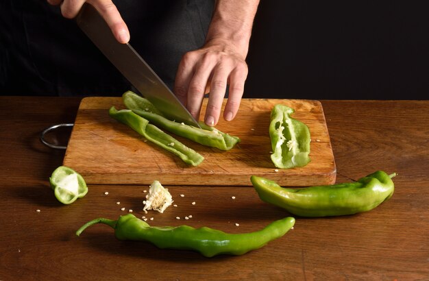 Chef cutting green pepper