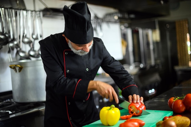 Chef cutting a red pepper