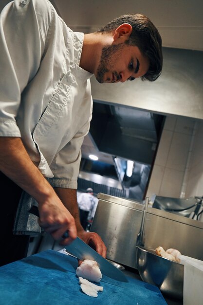 Chef cutting with knife